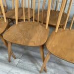 set of eight vintage ercol quaker dining chairs including two swan back carvers