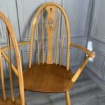 set of eight vintage ercol quaker dining chairs including two swan back carvers