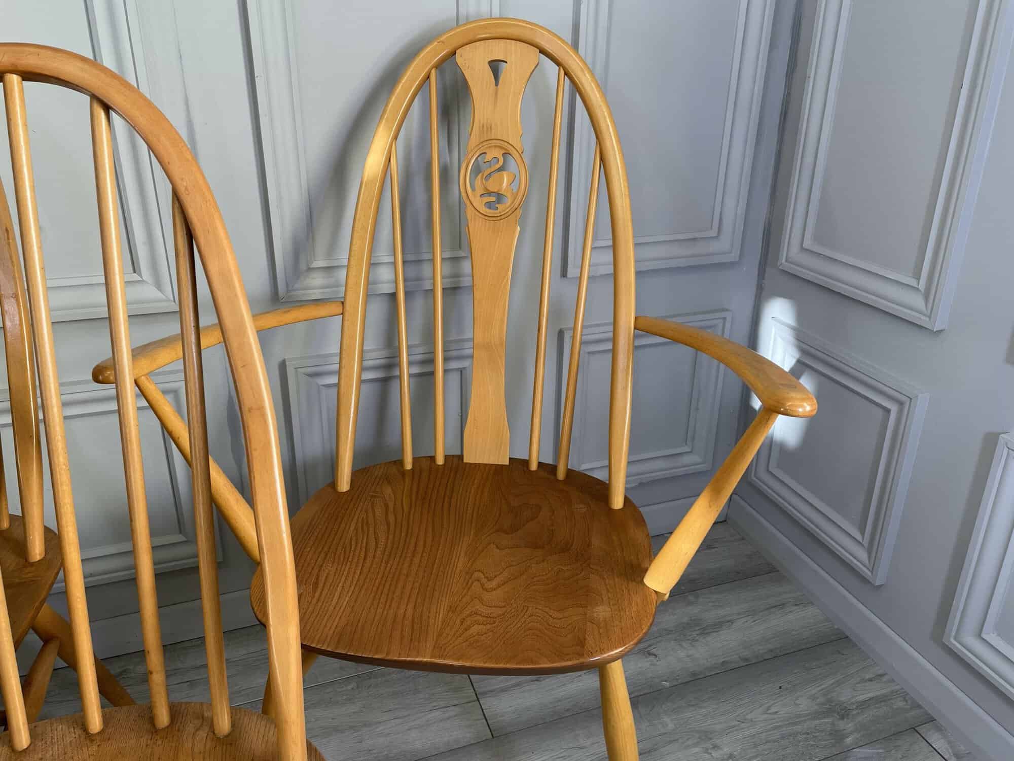 set of eight vintage ercol quaker dining chairs including two swan back carvers
