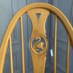 set of eight vintage ercol quaker dining chairs including two swan back carvers