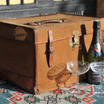 A vintage brown canvas and leather overnight weekend picnic classic car travel case trunk