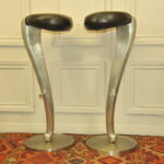 a pair of mid c swivel bar stools in solid pewter