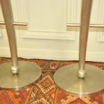 a pair of mid c swivel bar stools in solid pewter