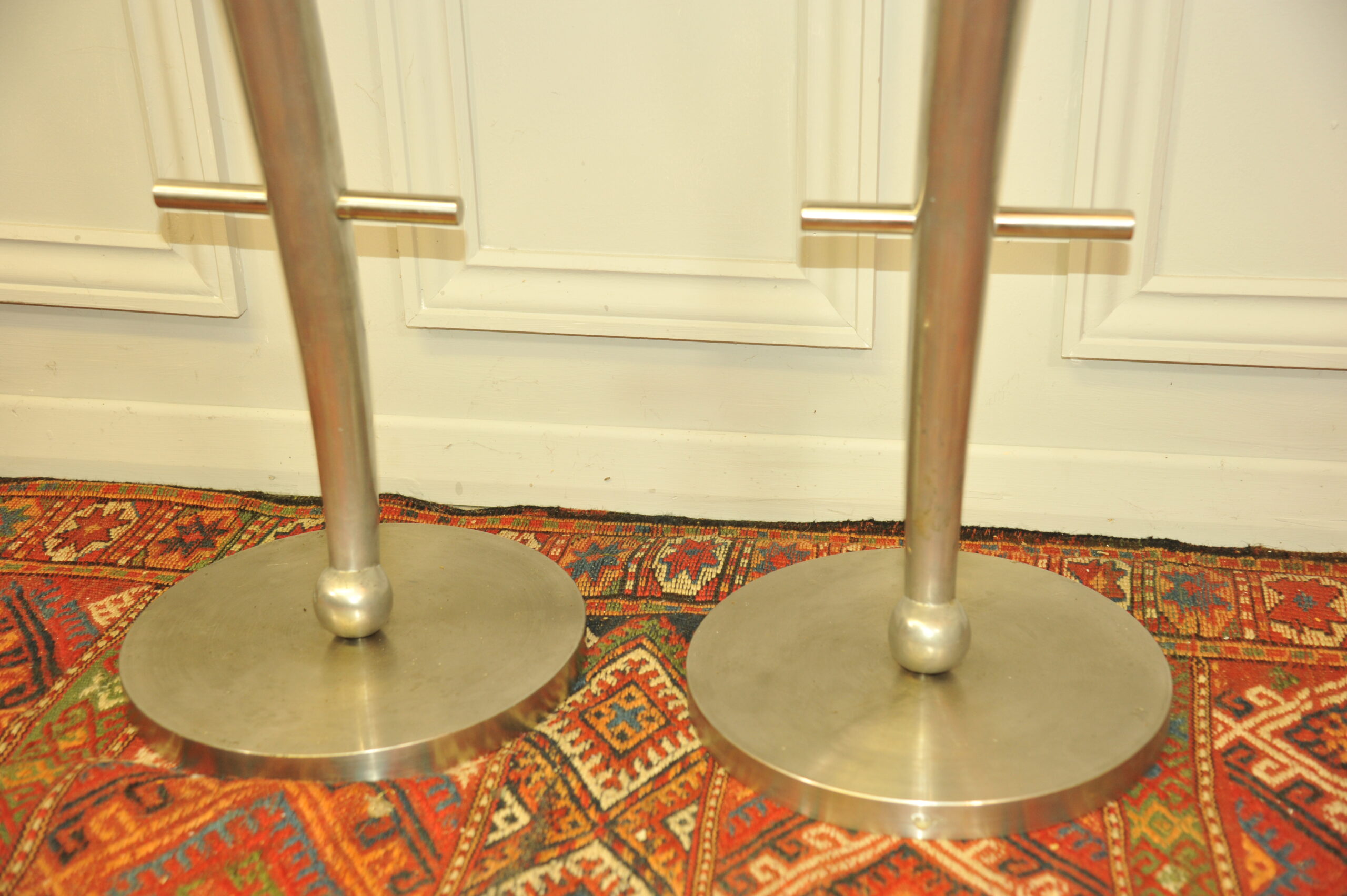 a pair of mid c swivel bar stools in solid pewter
