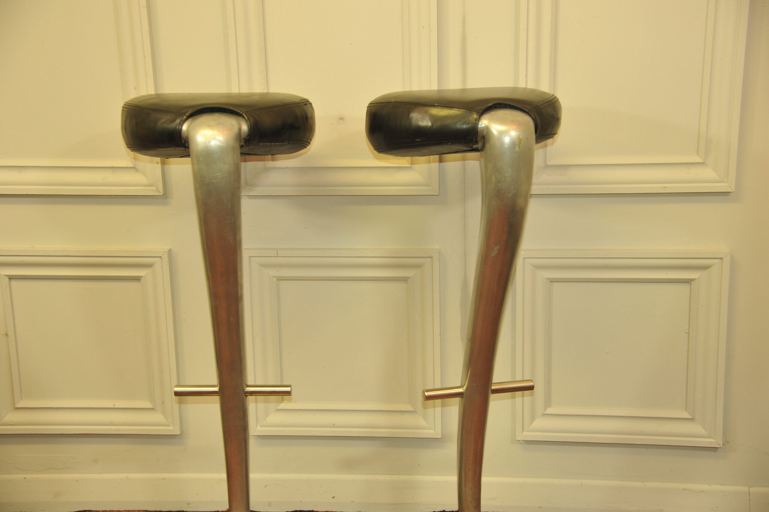 a pair of mid c swivel bar stools in solid pewter