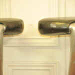 a pair of mid c swivel bar stools in solid pewter