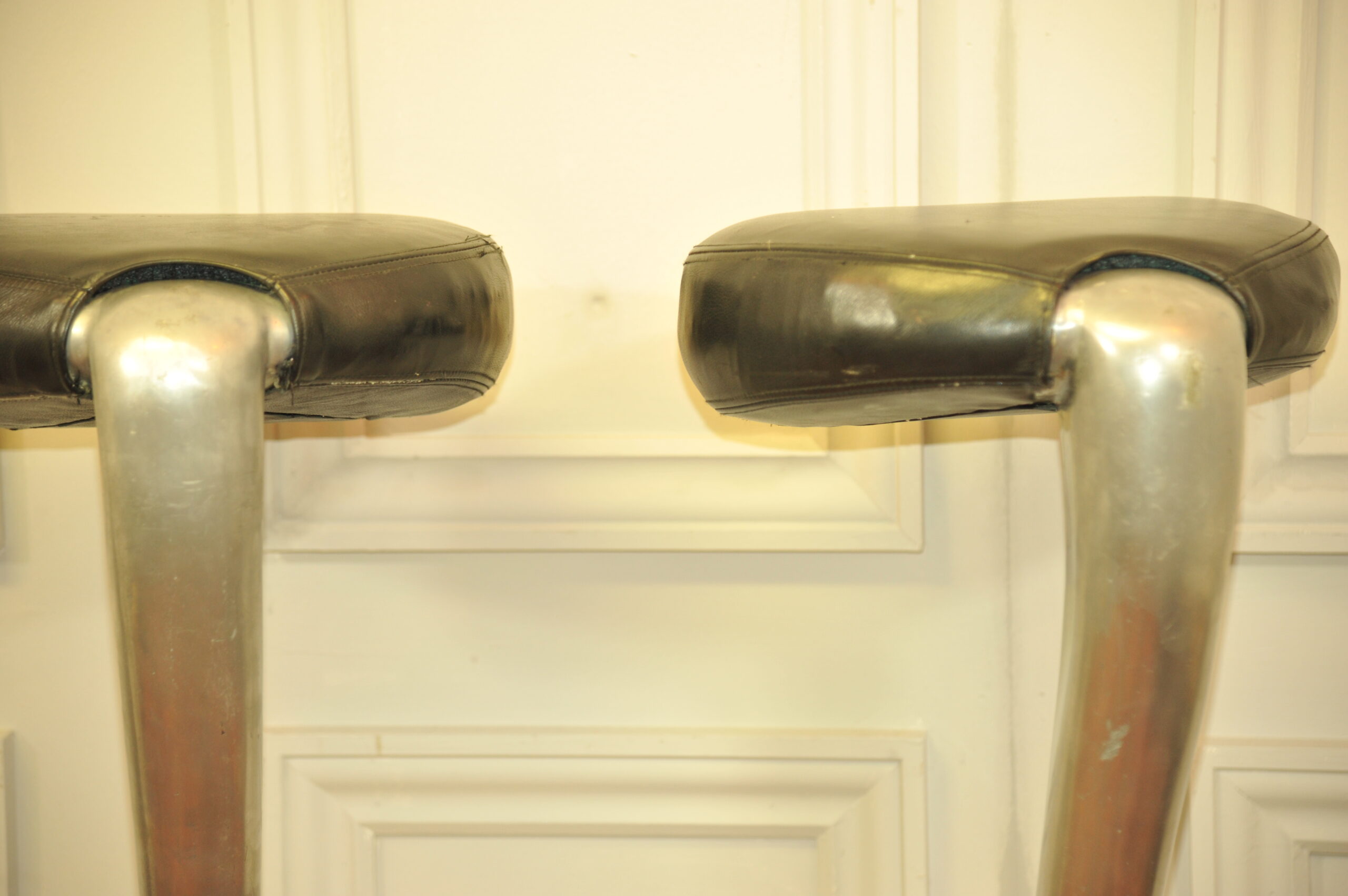 a pair of mid c swivel bar stools in solid pewter