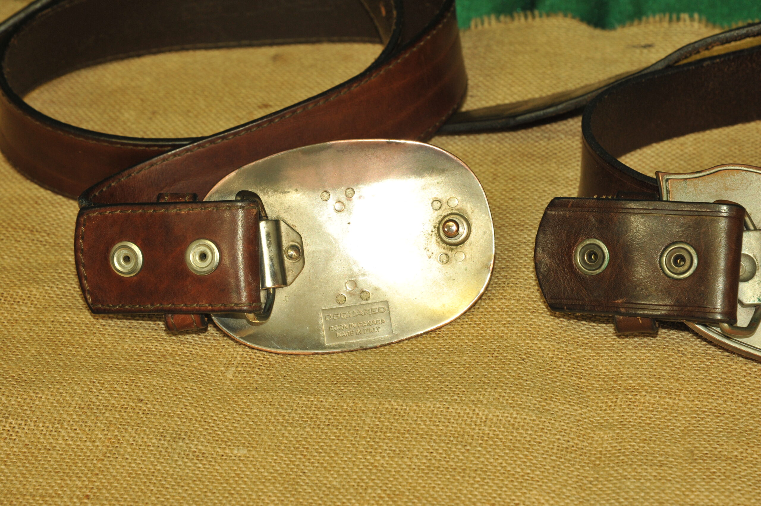 a pair of vintage collectible dsquared leather belts